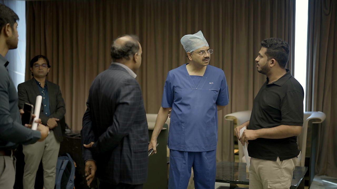Ram Prayaga, with healthcare leaders at their facility
